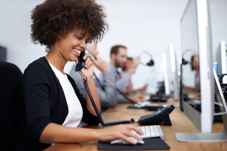 Woman on phone in office. Benefits of Upgrading Your In-House Phone System
