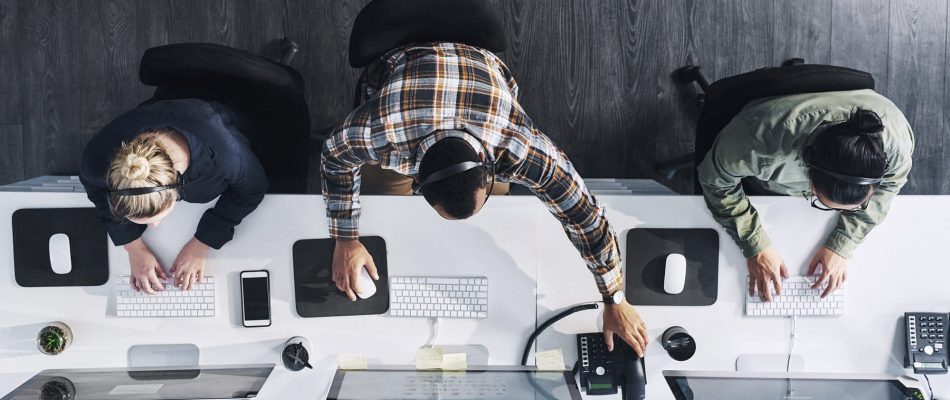 Team of professionals working together at a modern office desk.