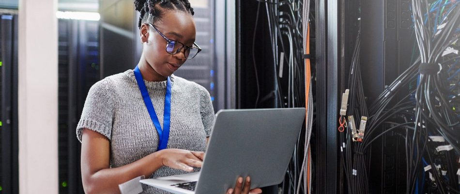 IT professional inspecting server rack in data center for size and setup.