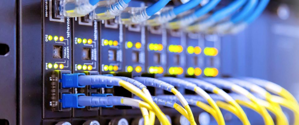 Close-up of shielded and unshielded Cat6a cables in a server rack.