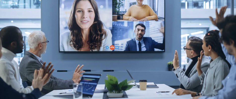 Business team participating in a Zoom video conference in a modern office.
