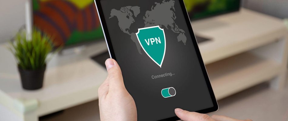 Person using tablet to connect to VPN with world map and shield icon.
